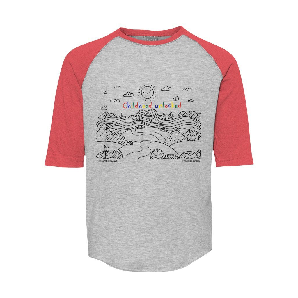 Child's line drawing of mountain range with "Childhood unlocked" written in primary colors. Cotton raglan jersey baseball tee. Youth t-shirt with 3/4 sleeves. Heather gray shirt with red sleeves and collar.