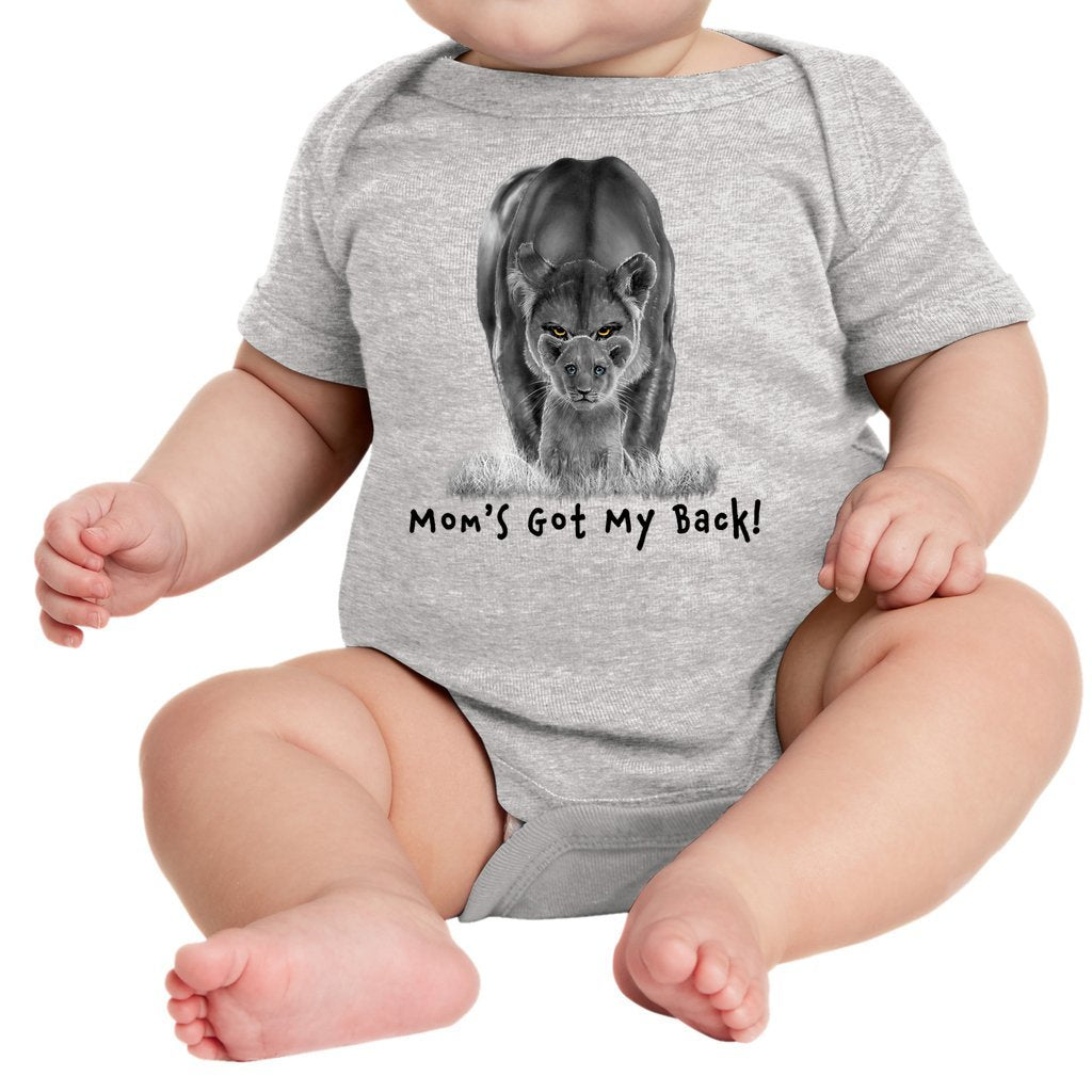 A lioness standing behind her sitting cub, with the words "Mom's Got My Back!" written below it on an infant onesie. Heather Gray.