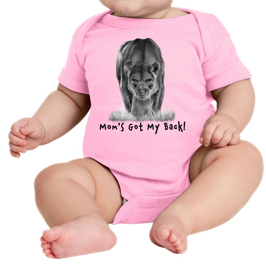 A lioness standing behind her sitting cub, with the words "Mom's Got My Back!" written below it on an infant onesie. Pink.