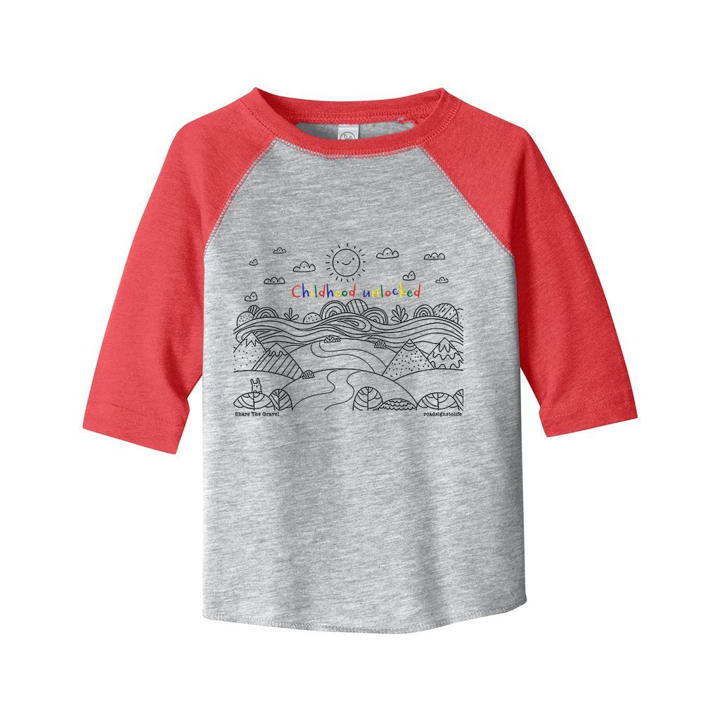 Child's line drawing of mountain range with "Childhood unlocked" written in primary colors. Cotton raglan jersey baseball tee. Toddler t-shirt with 3/4 sleeves. Heather gray shirt with red sleeves and collar.