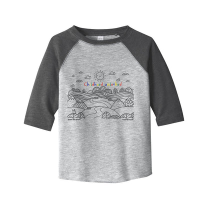Child's line drawing of mountain range with "Childhood unlocked" written in primary colors. Cotton raglan jersey baseball tee. Toddler t-shirt with 3/4 sleeves. Heather gray shirt with slate gray sleeves and collar.
